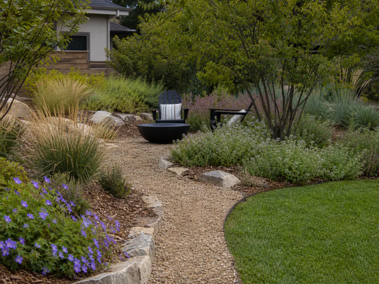 Garden path connecting planting, lawn, and a small seating area